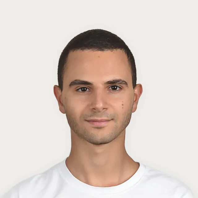 Joseph Zakher, smiling, in a white tee